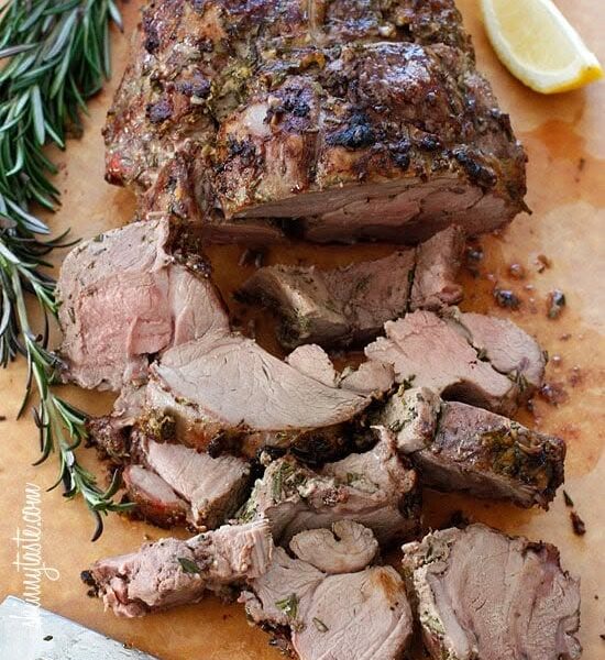 Sliced roast lamb served with rosemary.