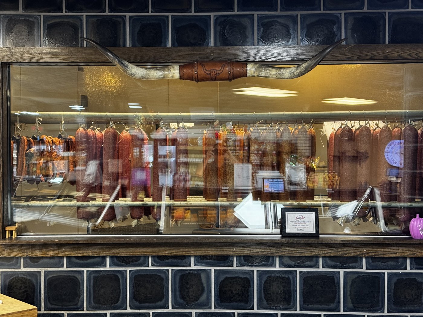 House-made meats hanging in Palumbo’s curing cabinet.