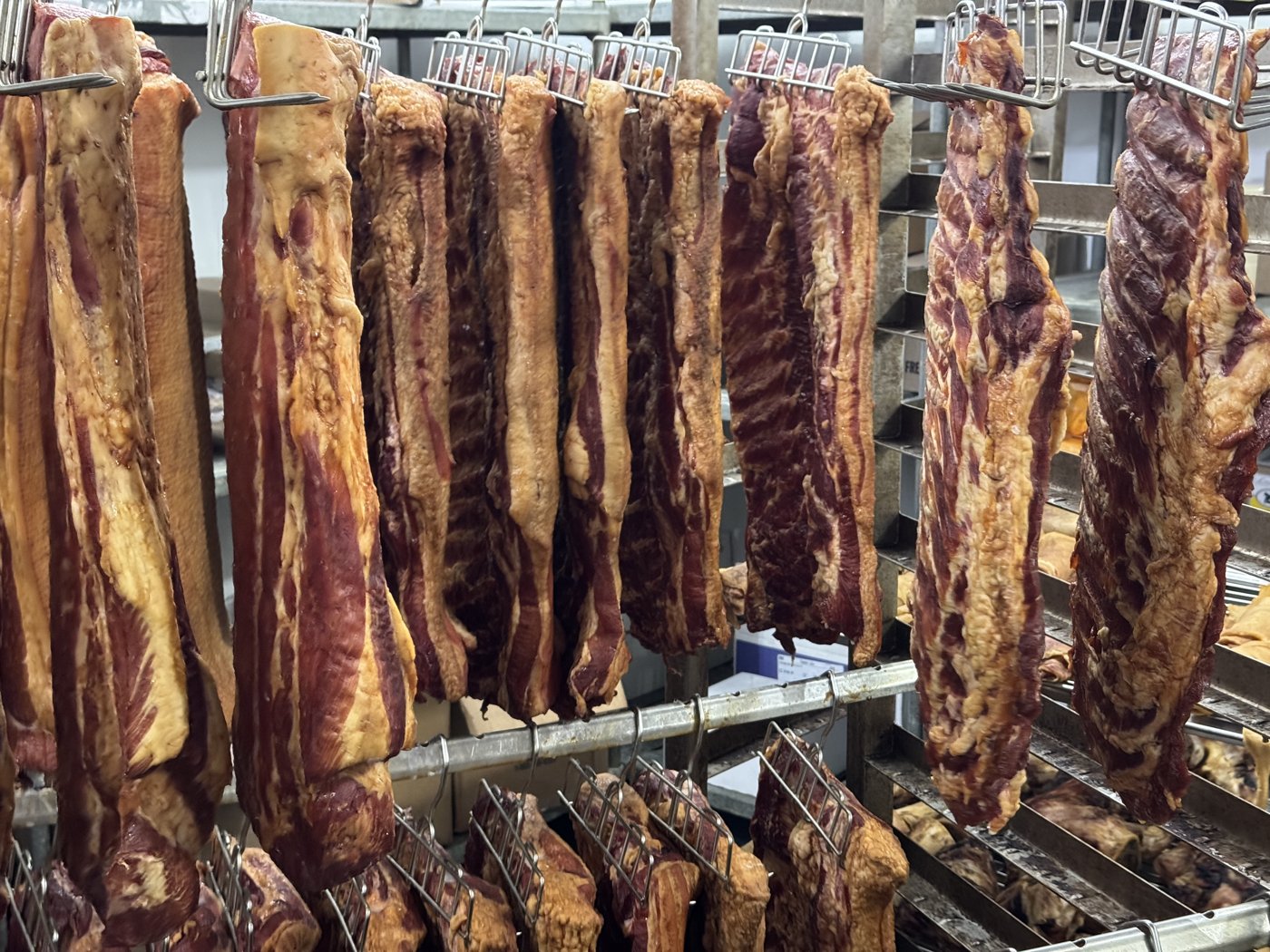 Bacon hanging on racks at Palumbo’s.