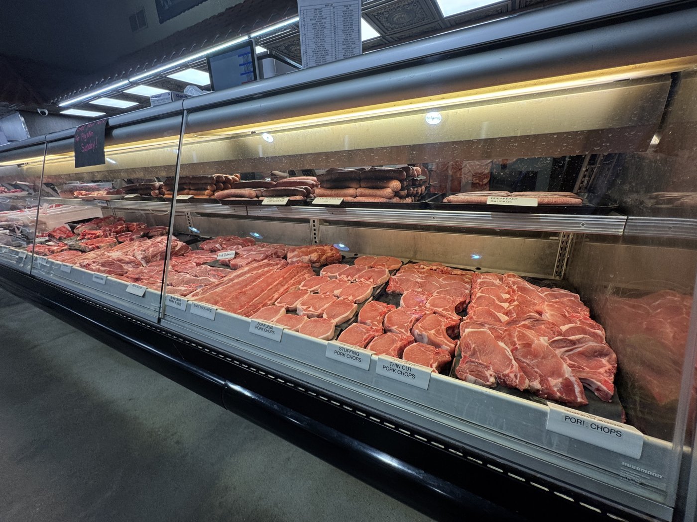 Pork cuts and sausage in the meat case.